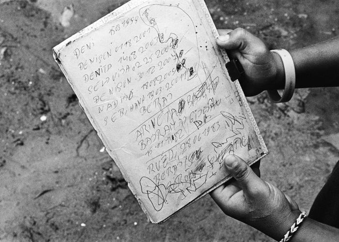 4.	Stateless Roma child in Serbia with a list of his and his siblings dates of birth © Greg Constantine